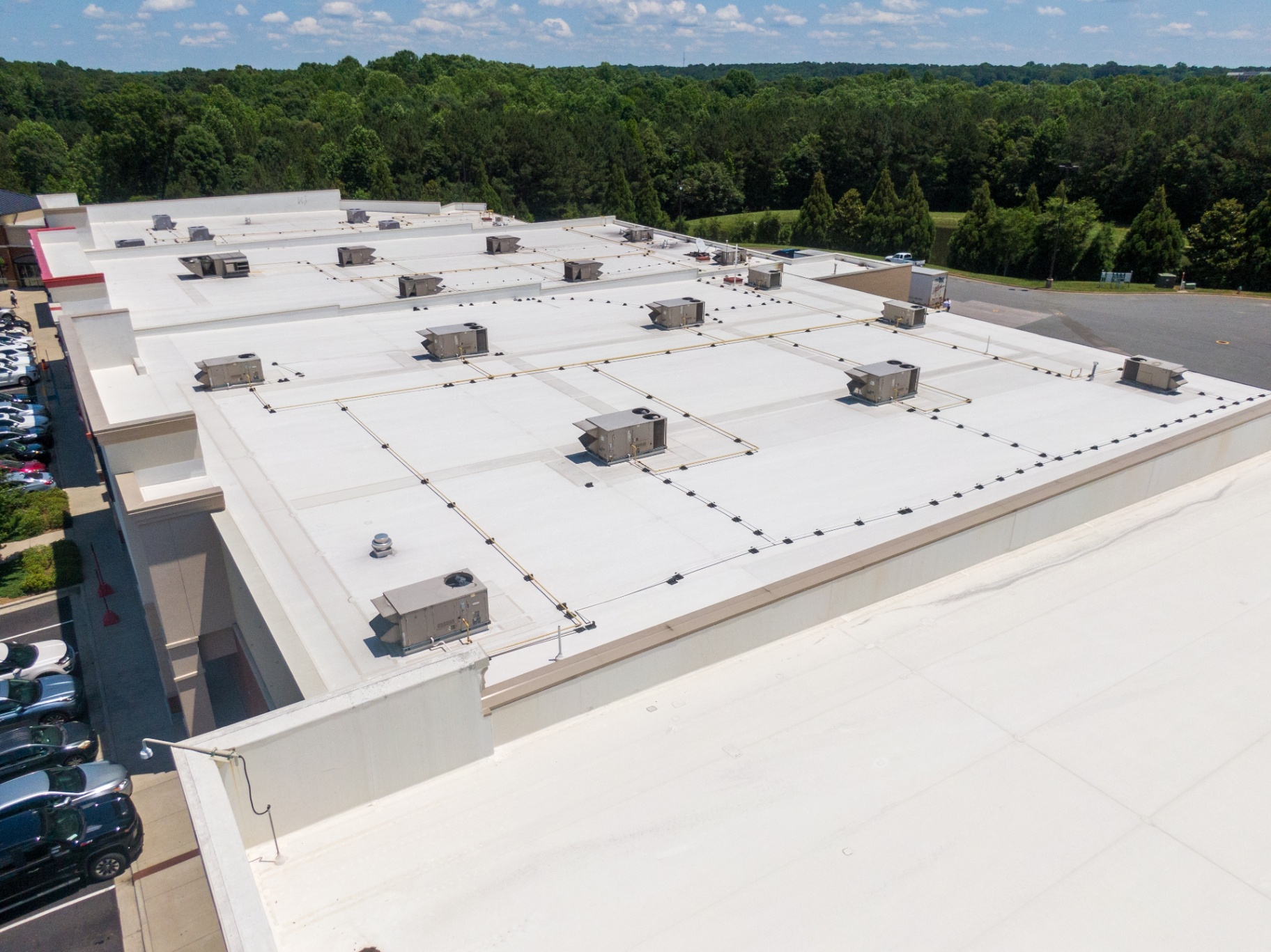 Large flat commercial roof with rooftop HVAC units after restoration