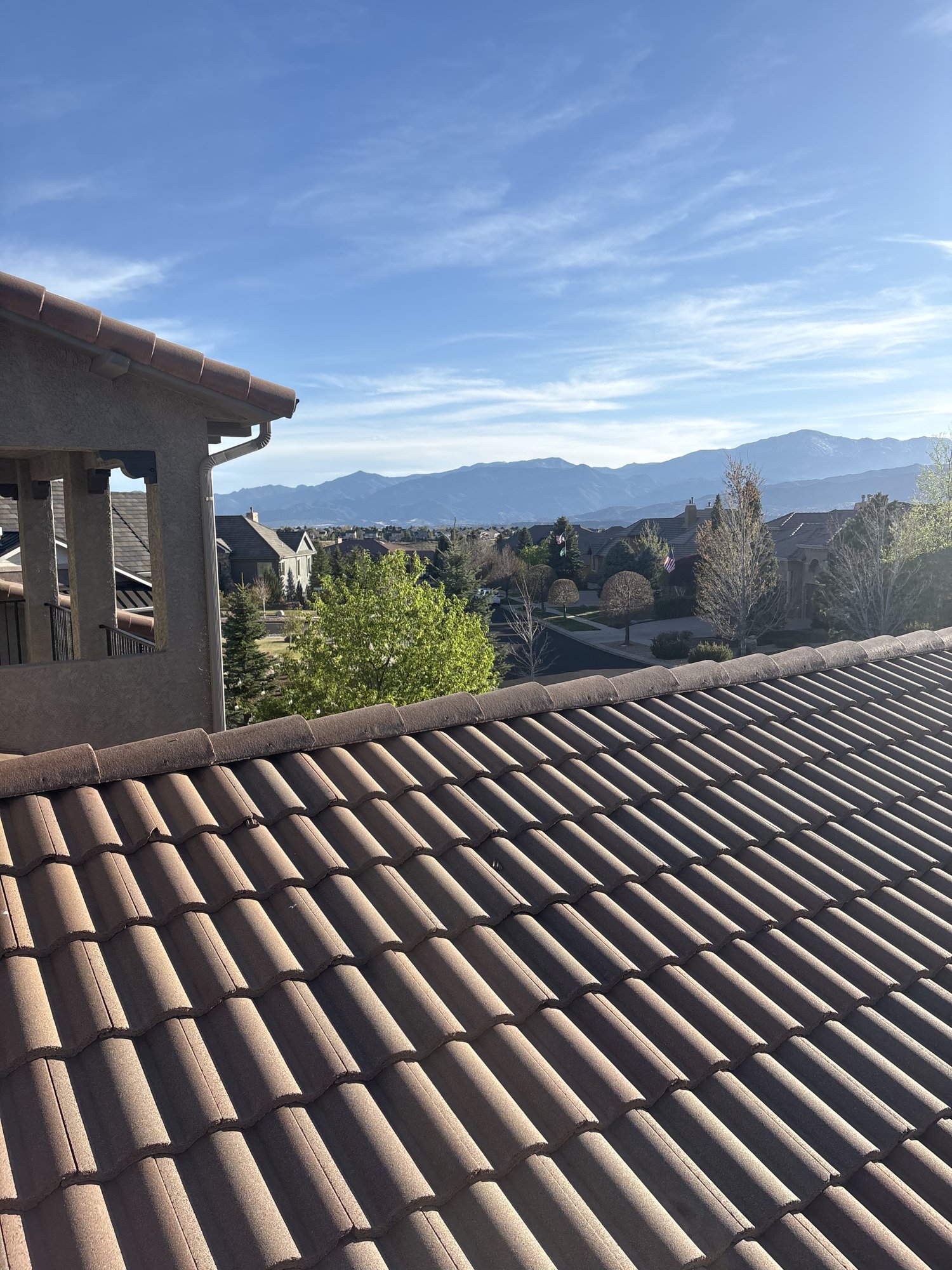 Clay tile residential roof in Colorado with Pikes Peak in the background
