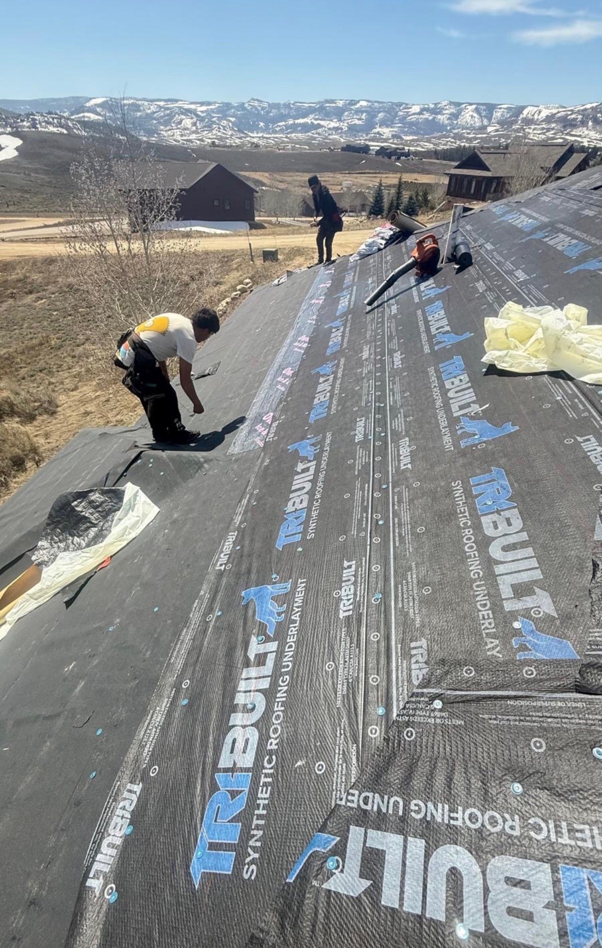 Mountain valley jobsite with synthetic underlayment laid