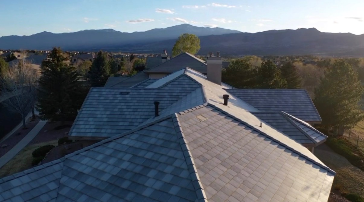 Completed stone-coated steel roof in front of Pikes Peak